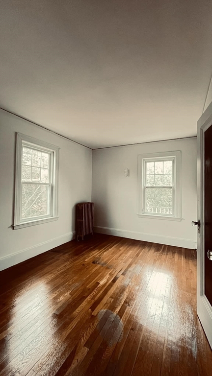 21 Lawrence Lane Belmont, MA 02478 - Photo 9 of 13 an empty room with wooden floor and windows