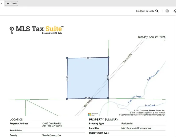 a view of a green field with wooden fence