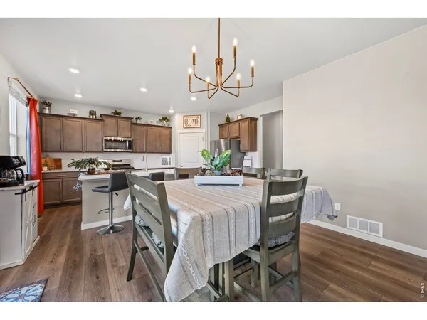 a view of a dining room with furniture and a chandelier