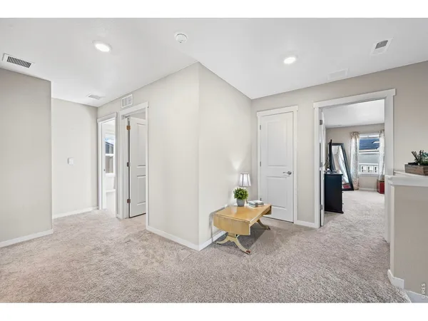 a living room with furniture and a dining table