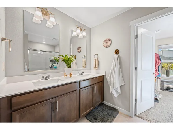 a bathroom with a double vanity sink and a mirror