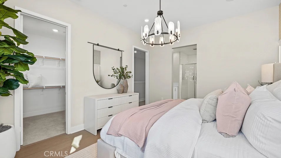 15 Merit Irvine, CA 92618 - Photo 11 of 33 a bedroom with a bed and a chandelier