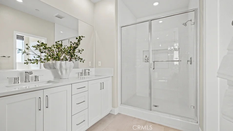 15 Merit Irvine, CA 92618 - Photo 12 of 33 a bathroom with a shower sink and mirror