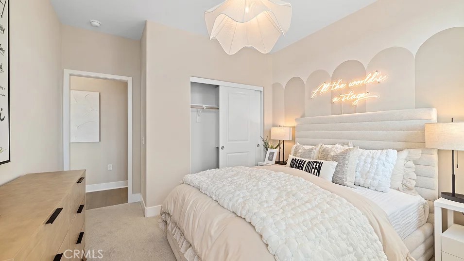 15 Merit Irvine, CA 92618 - Photo 15 of 33 a bedroom with a bed and a chandelier
