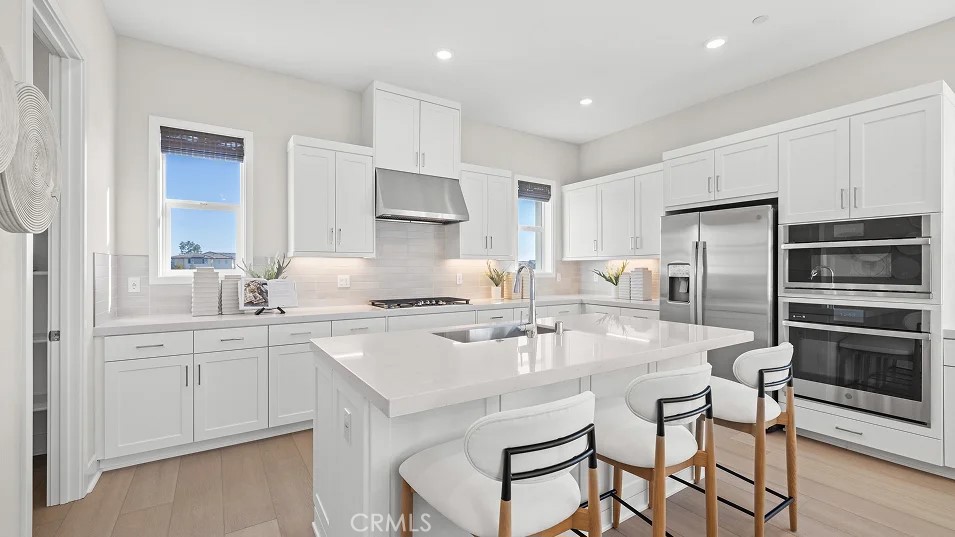 15 Merit Irvine, CA 92618 - Photo 2 of 33 a kitchen with kitchen island granite countertop a sink cabinets and stainless steel appliances