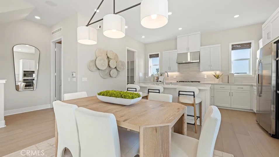 15 Merit Irvine, CA 92618 - Photo 5 of 33 a kitchen with a table chairs stove and cabinets
