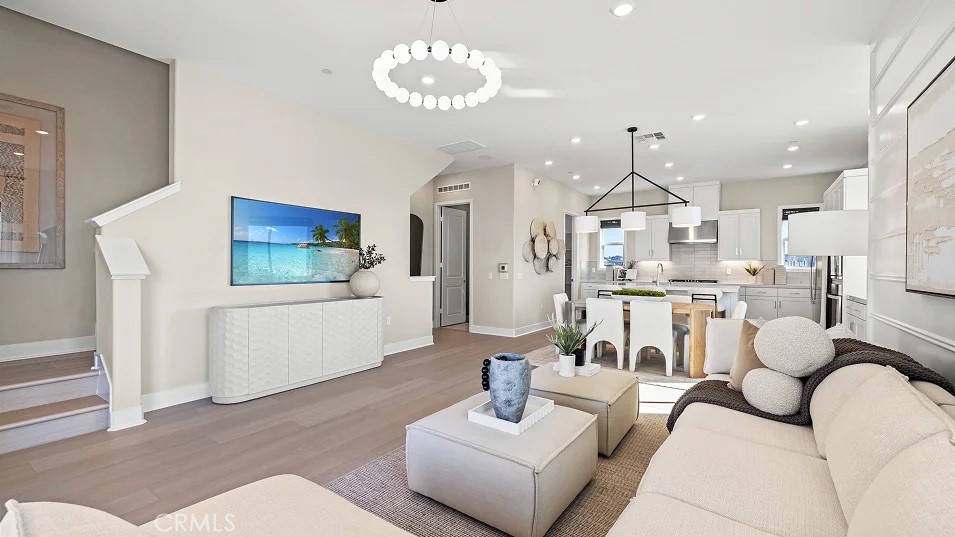 15 Merit Irvine, CA 92618 - Photo 7 of 33 a living room with furniture kitchen view and a chandelier