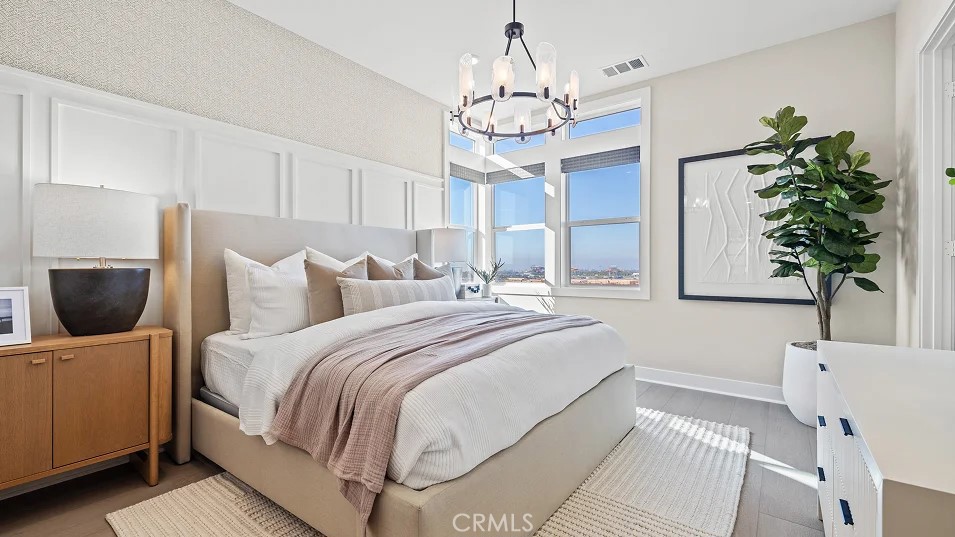 15 Merit Irvine, CA 92618 - Photo 10 of 33 a spacious bedroom with a bed and a chandelier