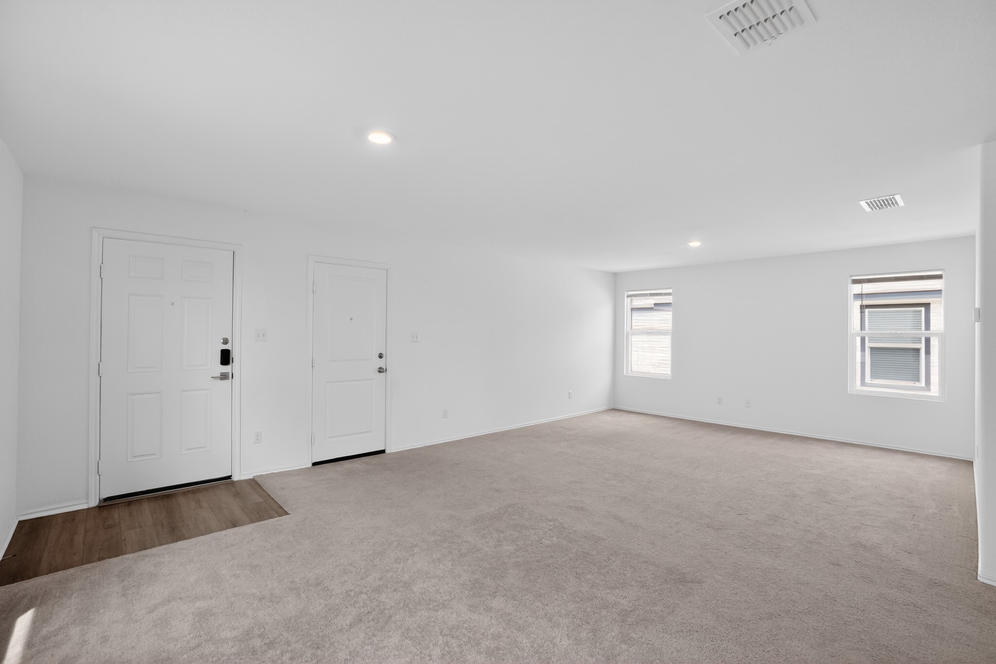 604 Marty Allen Loop Jarrell, TX 76537 - Photo 5 of 15 Enter into a vast, carpeted living area featuring dual entry doors and abundant natural light.