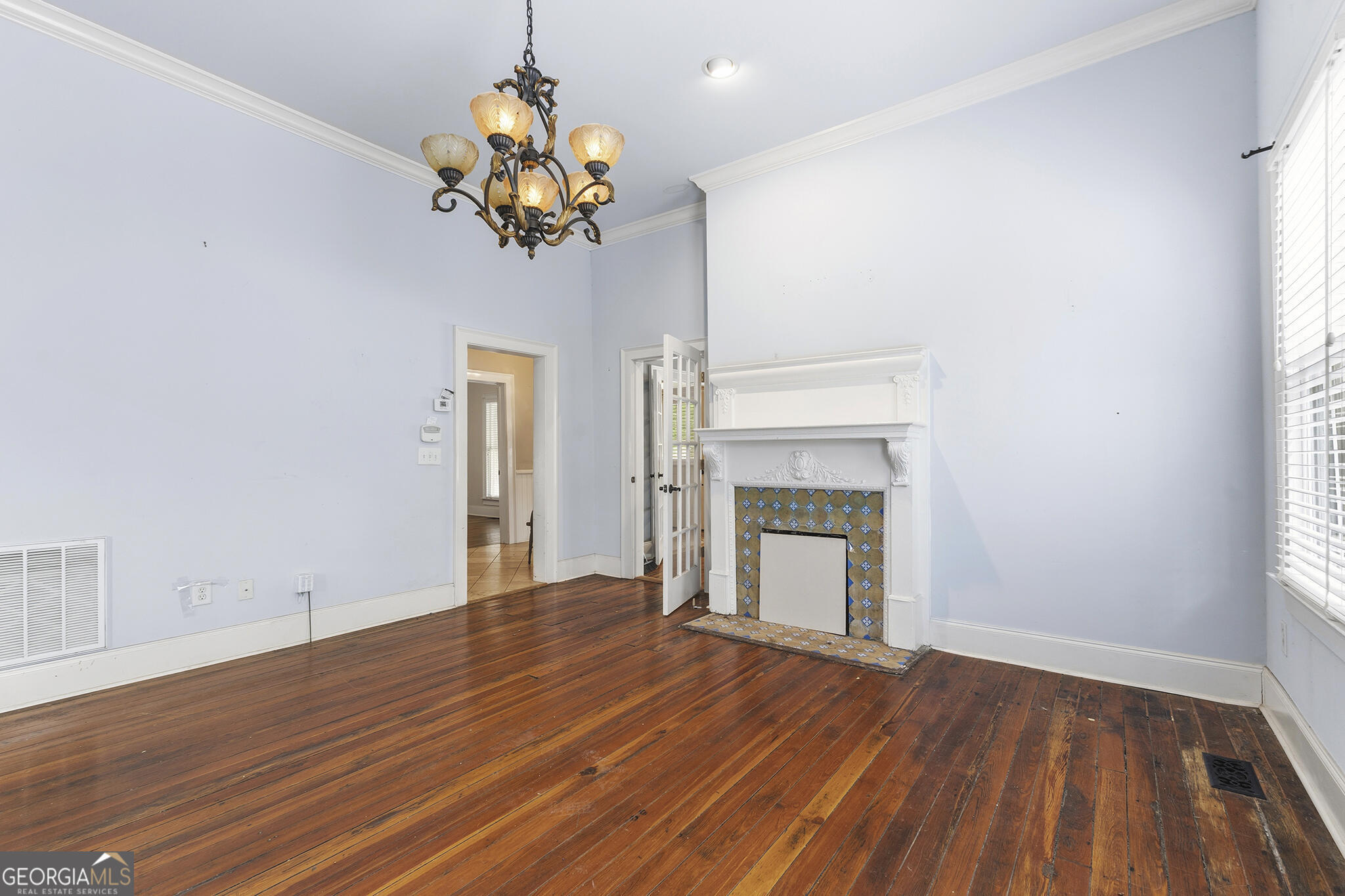 1469 Chestnut Street Macon, GA 31201 - Photo 18 of 26 a view of an empty room with a fireplace and a window
