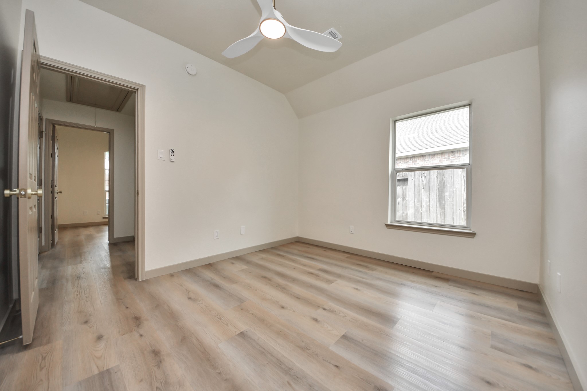 14423 Gadwall Court Houston, TX 77044 - Photo 13 of 42 an empty room with wooden floor and windows