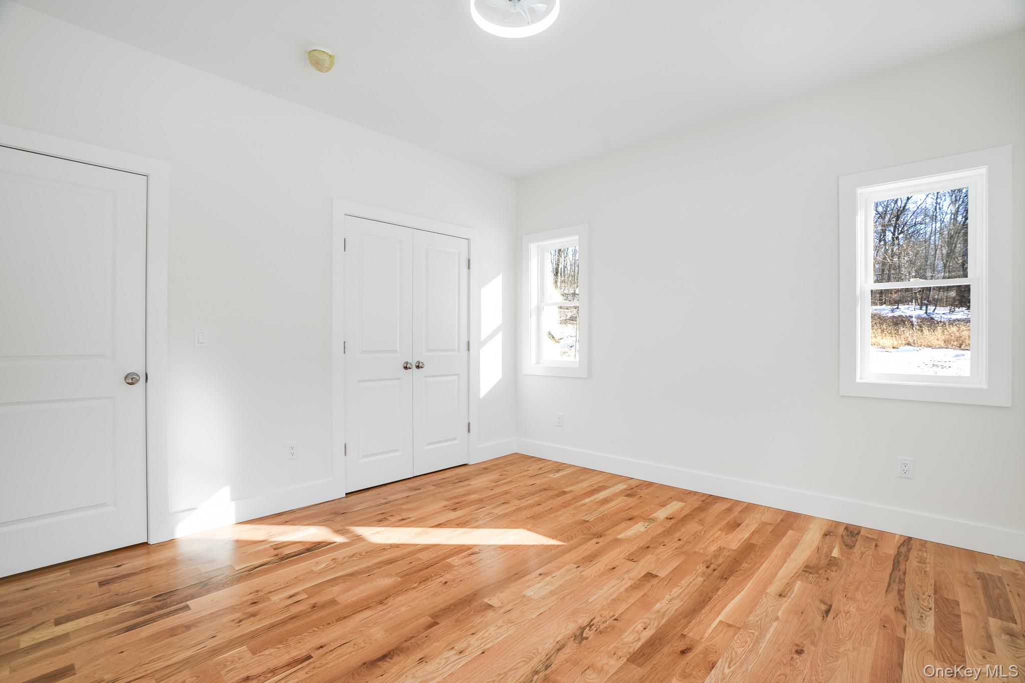 6 Roundhill Road Hopewell Junction, NY 12533 - Photo 14 of 23 an empty room with wooden floor and windows