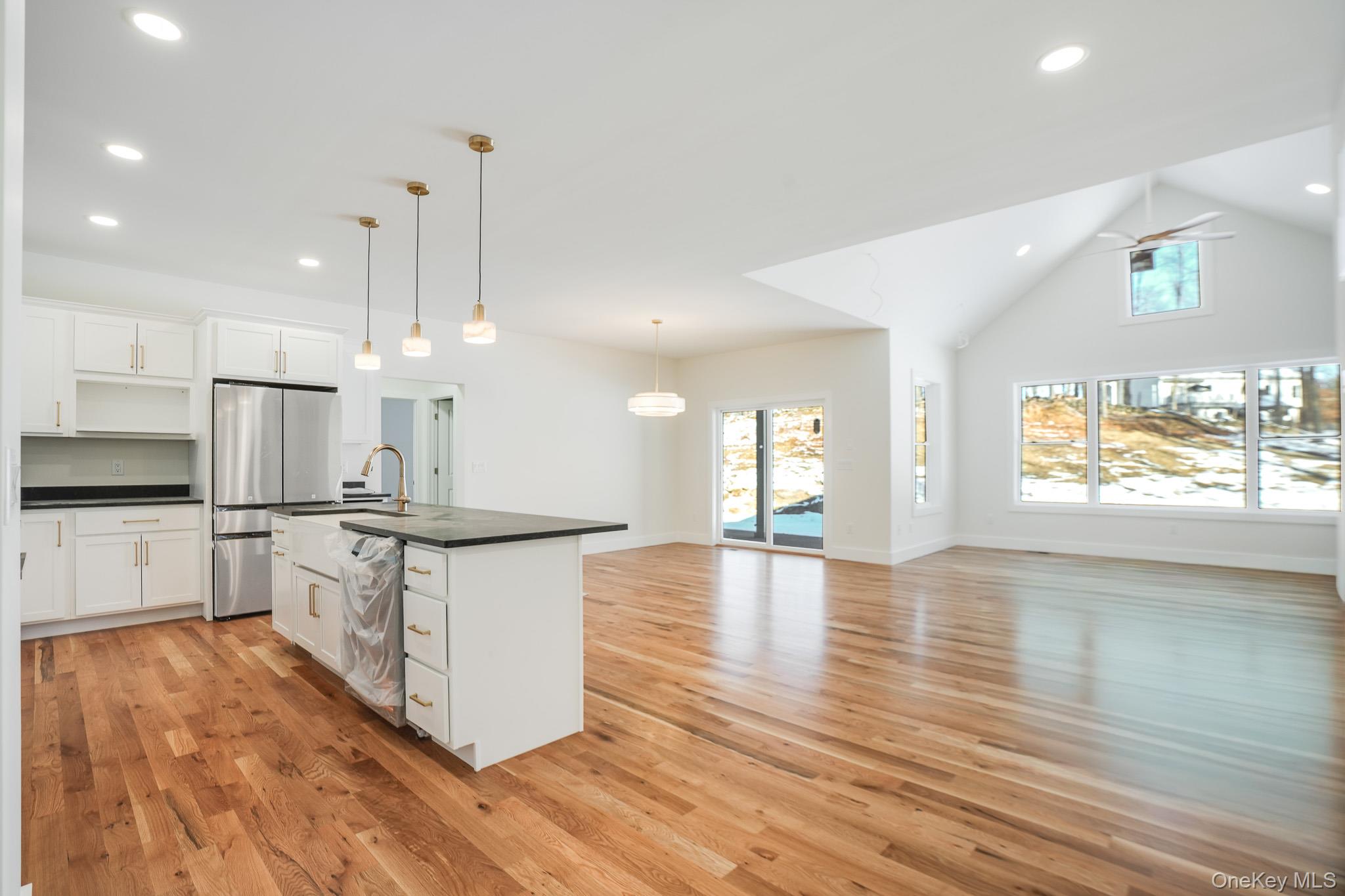 6 Roundhill Road Hopewell Junction, NY 12533 - Photo 2 of 23 a large kitchen with stainless steel appliances a large counter top a stove a sink dishwasher and a refrigerator with wooden floor