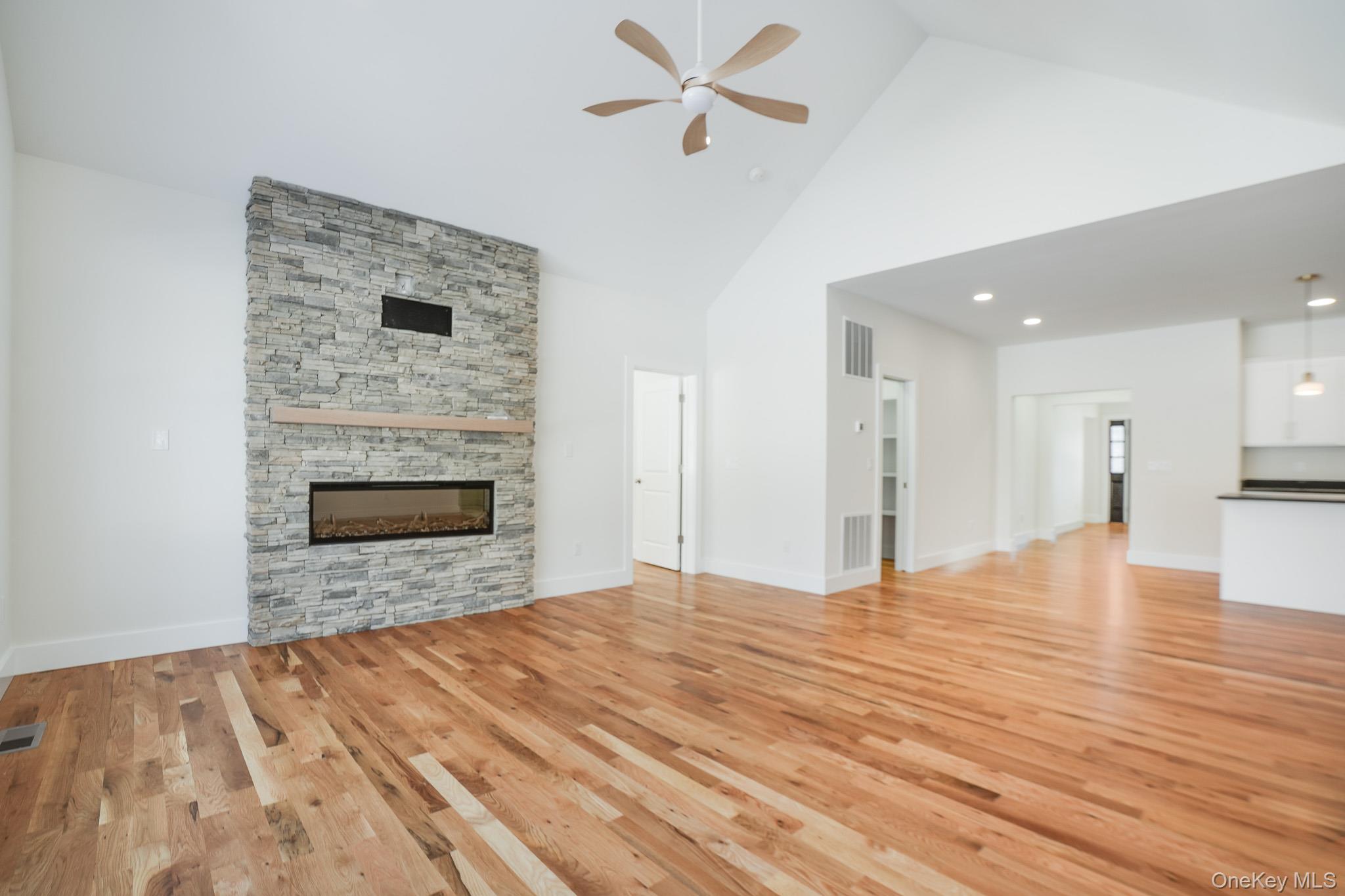6 Roundhill Road Hopewell Junction, NY 12533 - Photo 4 of 23 a view of empty room with wooden floor and fireplace