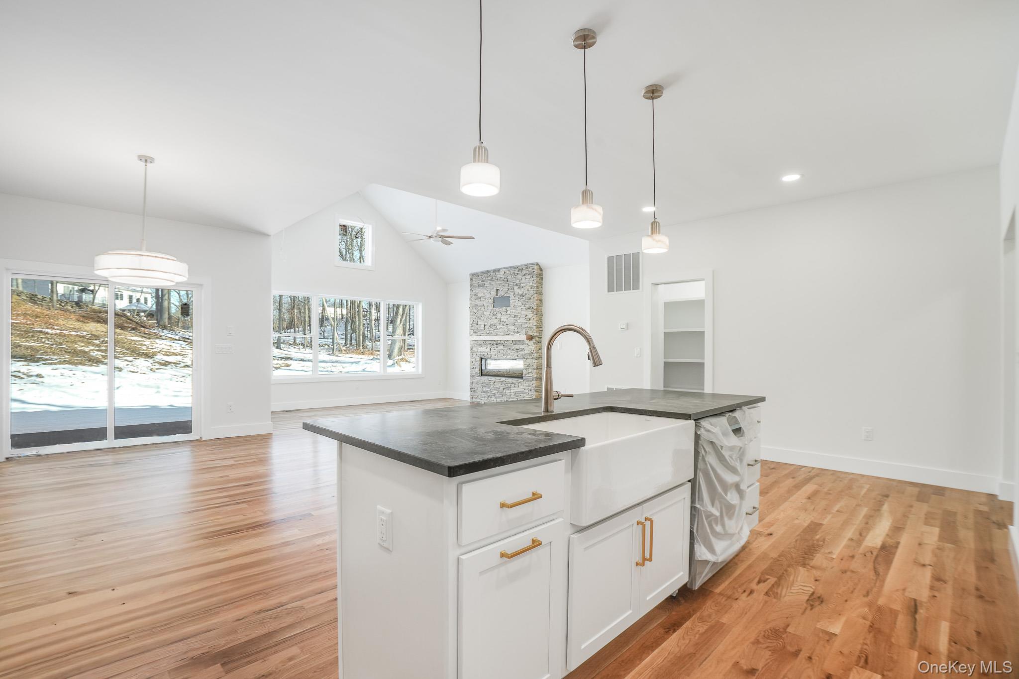 6 Roundhill Road Hopewell Junction, NY 12533 - Photo 6 of 23 a kitchen with stainless steel appliances granite countertop a sink a stove and a wooden floor