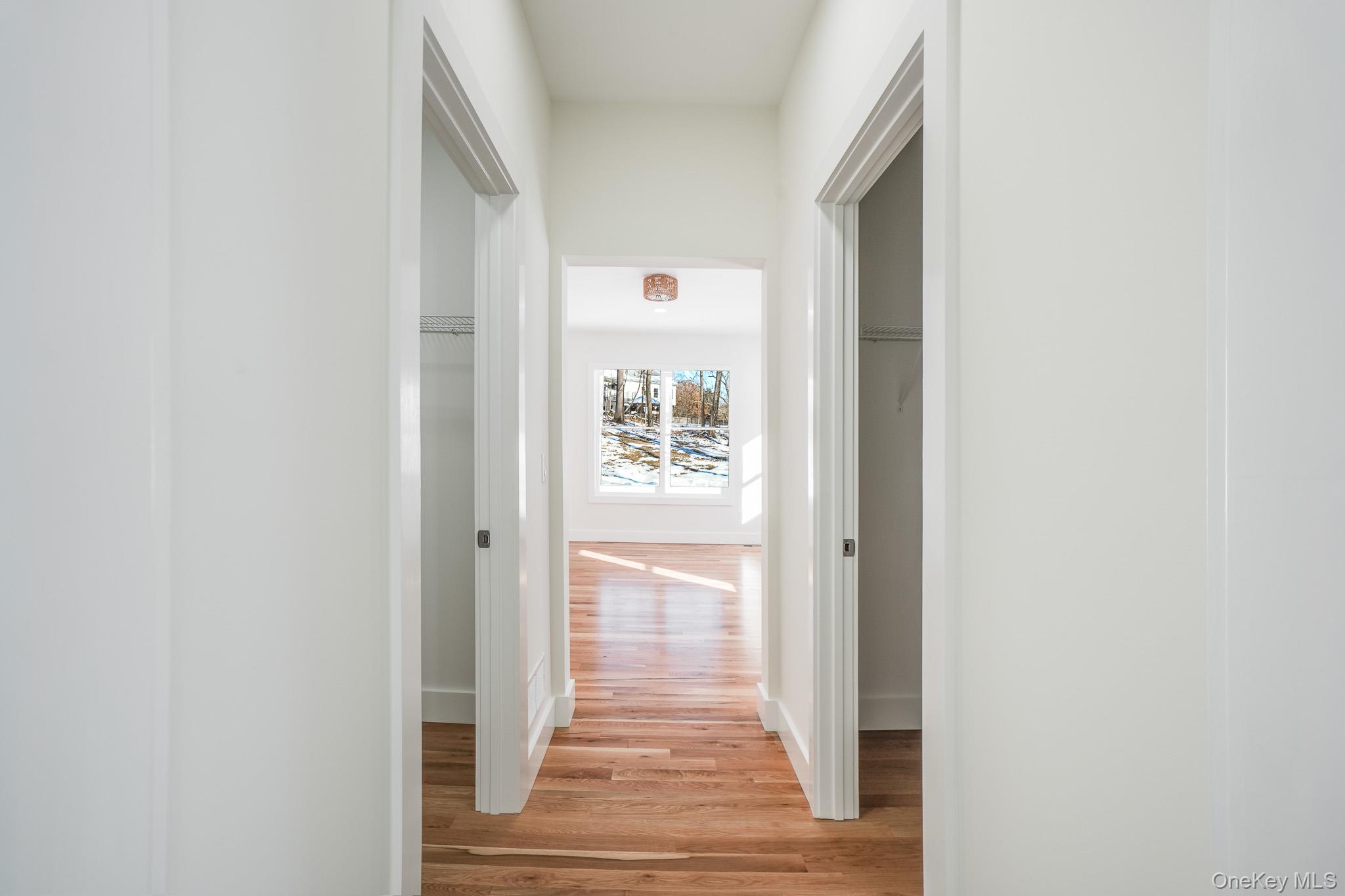 6 Roundhill Road Hopewell Junction, NY 12533 - Photo 9 of 23 a view of a hallway with wooden floor and a white door