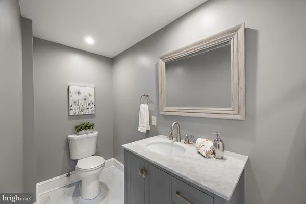 a bathroom with a toilet sink and mirror