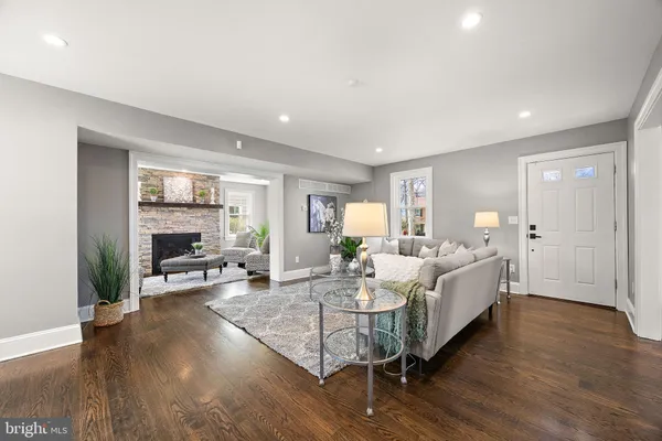 a living room with furniture wooden floor and a fireplace