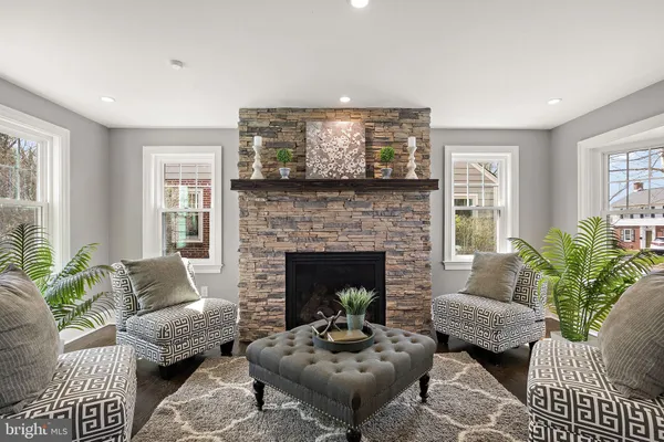 a living room with furniture and a fireplace