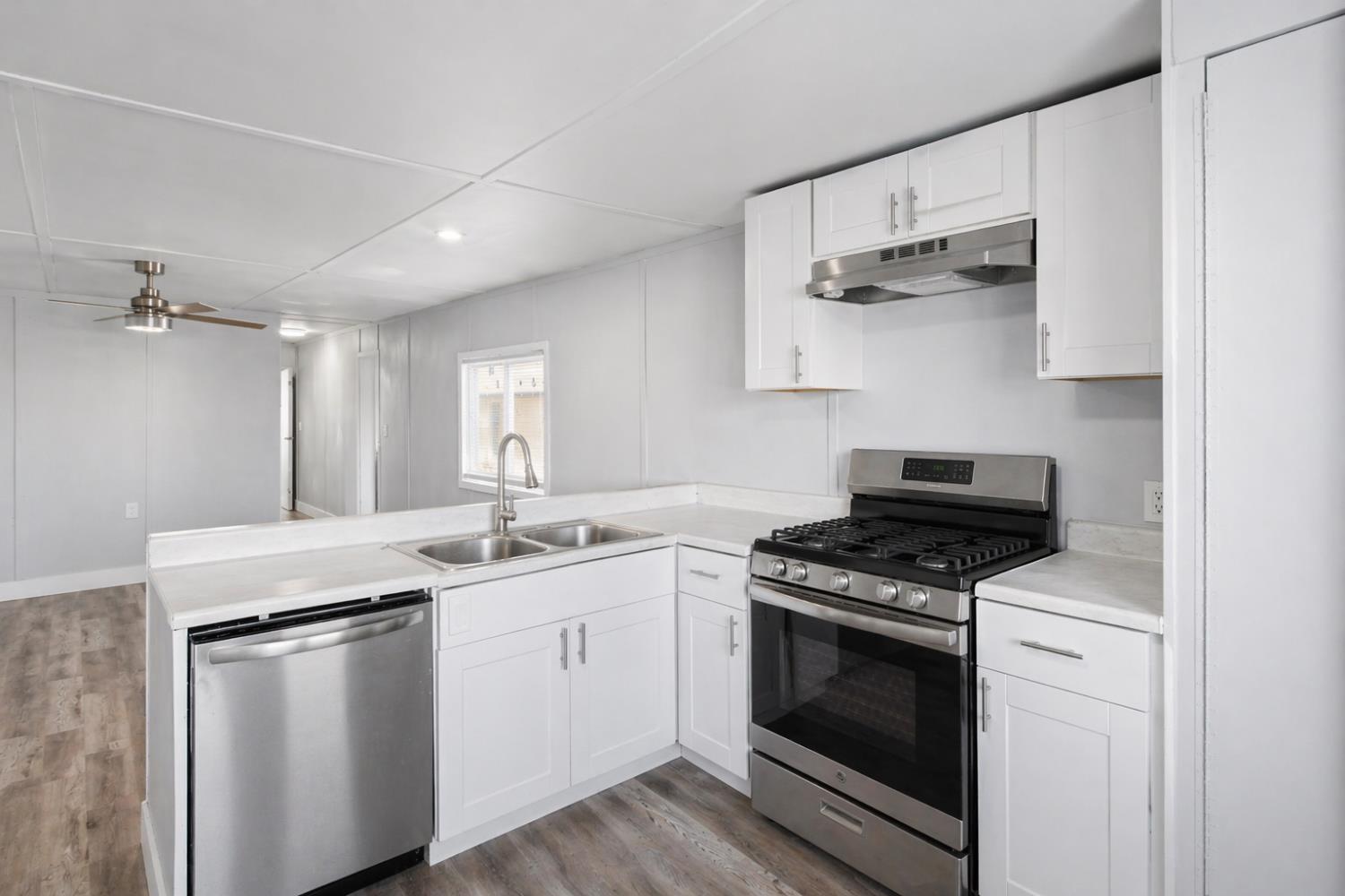 5508 Keith Court, Unit 19 Turlock, CA 95382 - Photo 4 of 13 a kitchen with white cabinets and appliances