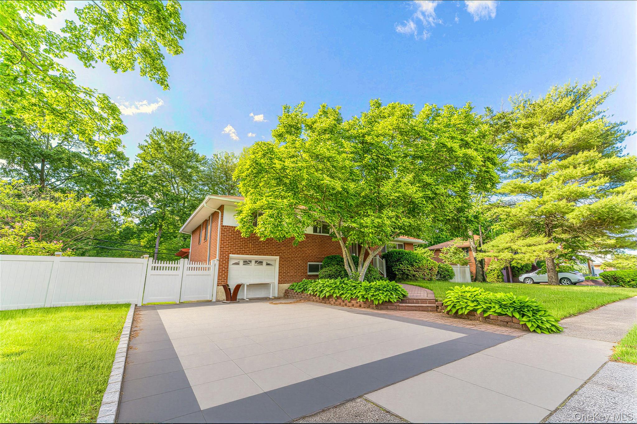 105 Seaman Road Jericho, NY 11753 - Photo 1 of 11 a front view of a house with a yard and a garage