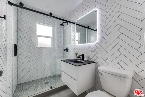 a bathroom with a sink toilet and shower