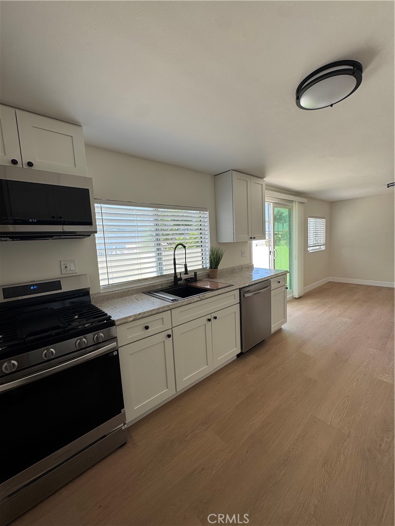 a kitchen with granite countertop a stove and a sink