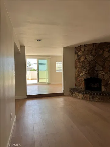 an empty room with fireplace and a window