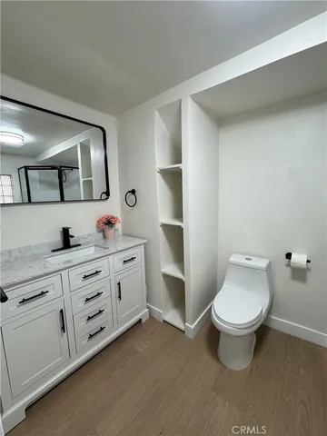 a bathroom with a double vanity sink toilet and mirror