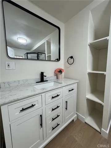 a bathroom with a double vanity sink and a mirror