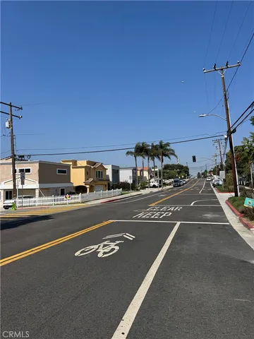 a view of a city street with a car parked on the road