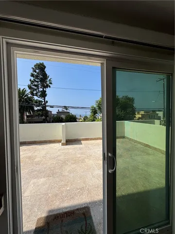 a view of a glass door and a window