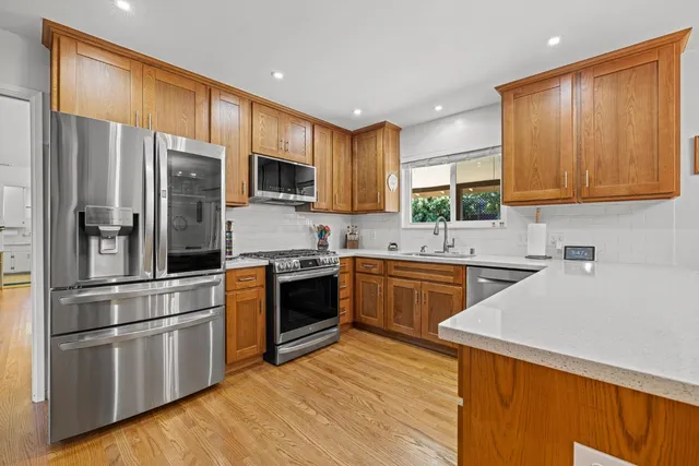 a bedroom with a bed and a dresser next to a window