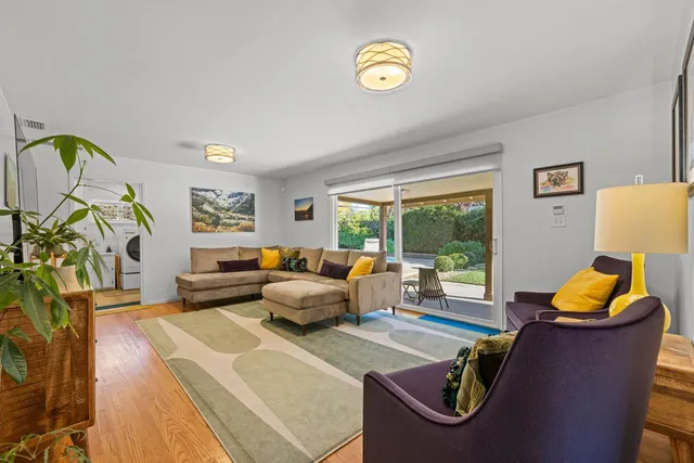 a living room with furniture and a lamp