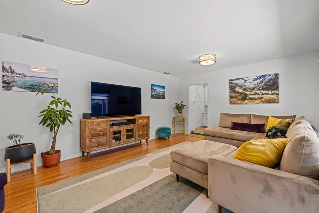 a living room with furniture and wooden floor