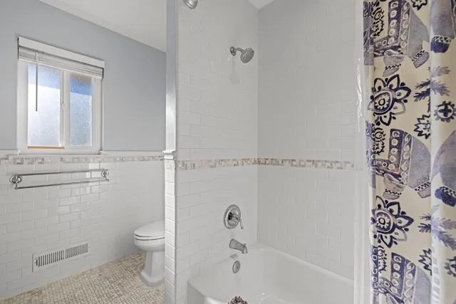 a view of backyard of house with outdoor seating and green space