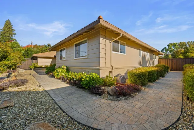 a kitchen with stainless steel appliances a stove microwave and sink