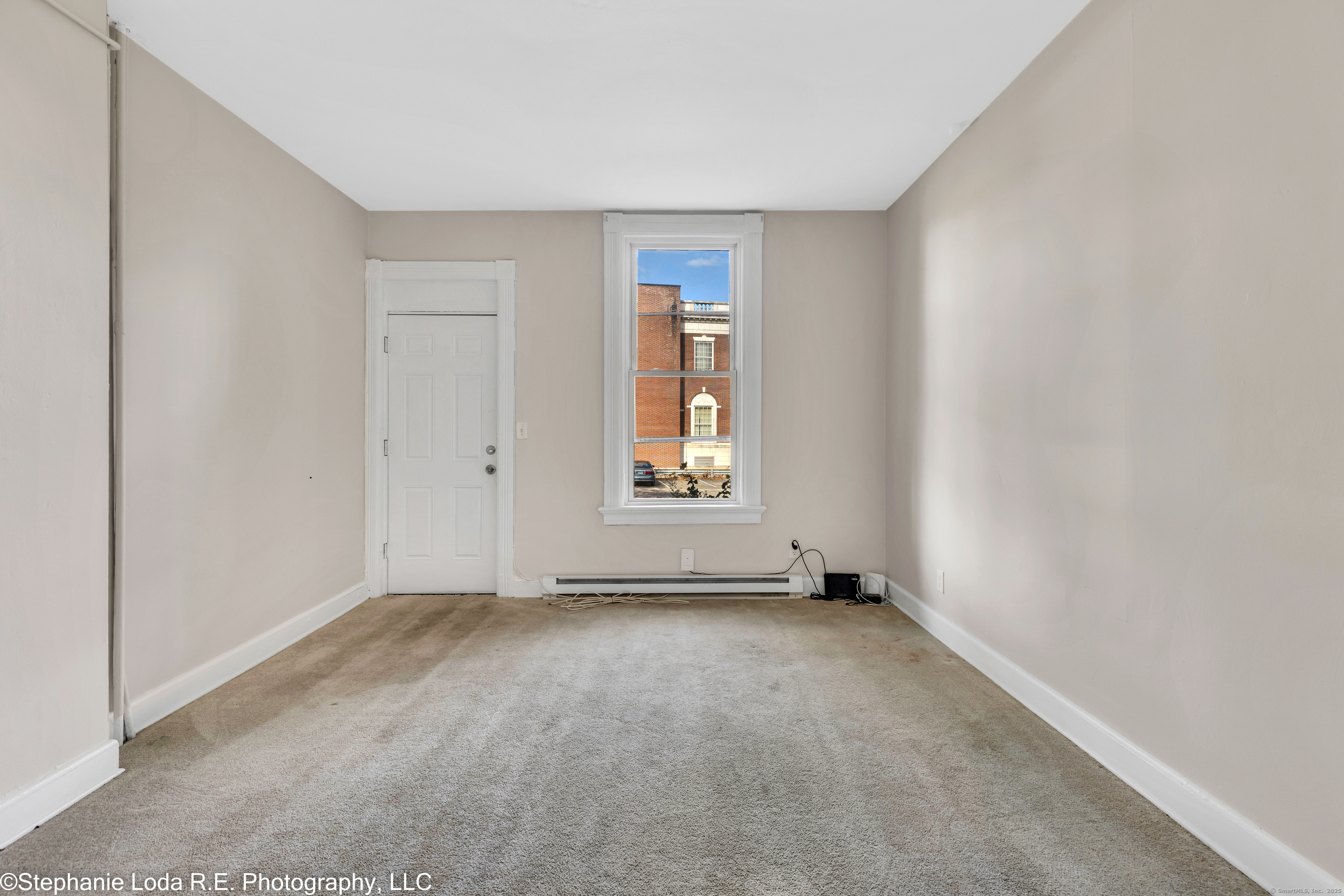 82 Water Street, Unit 2 Torrington, CT 06790 - Photo 12 of 20 a view of an empty room with a window