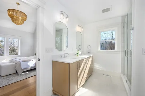a en suite bathroom with a double vanity sink and a mirror