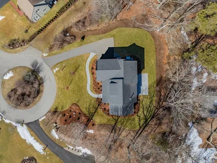 an aerial view of a house with a yard