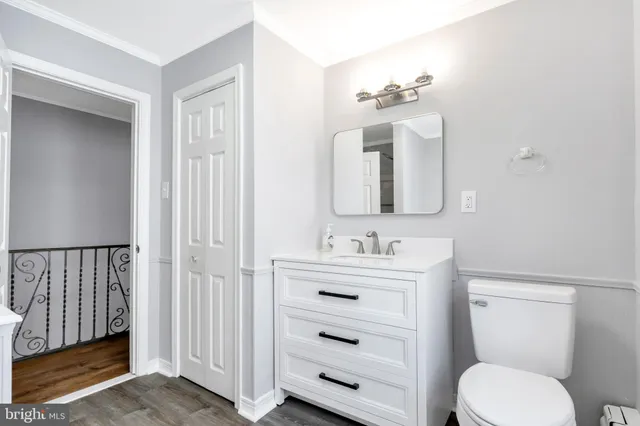 a bathroom with a toilet a sink and mirror