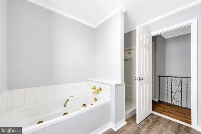 a bathroom with bathtub and shower