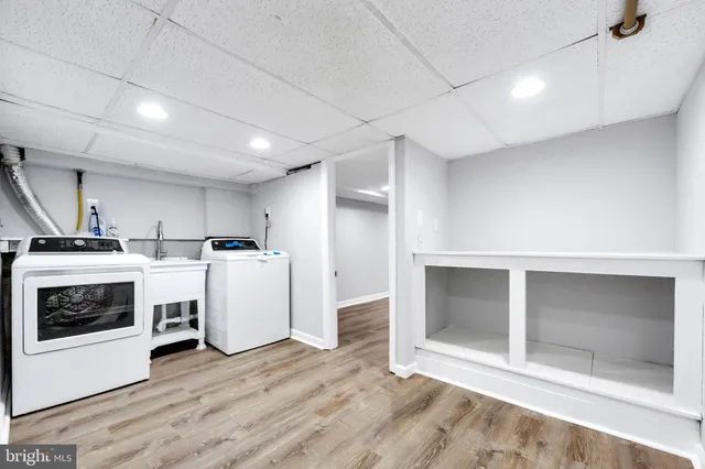 a view of a kitchen with white cabinets and white appliances