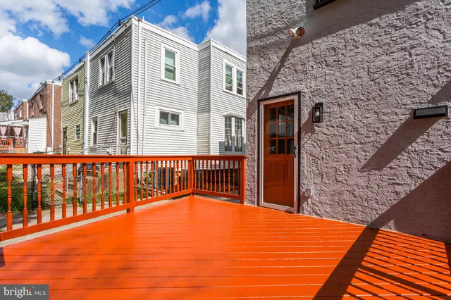 a view of a balcony with a floor to ceiling window and wooden fence