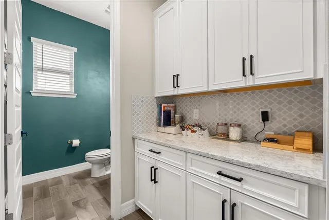 a living room with furniture a rug and a flat screen tv