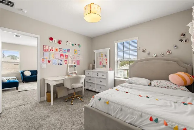 a bathroom with a granite countertop double vanity and a mirror