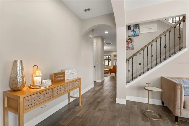 a living room with furniture and a floor to ceiling window