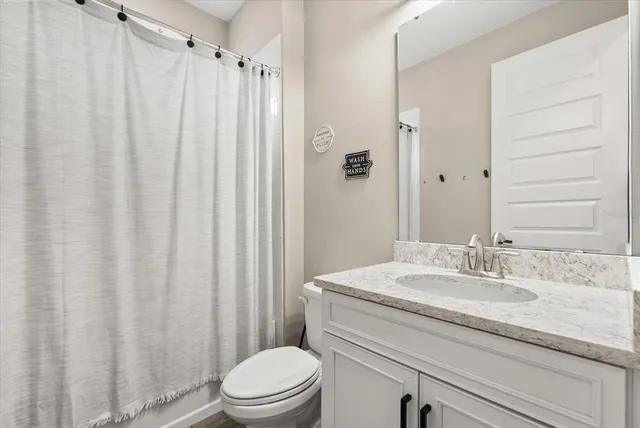 a living room with furniture flowerpot and window