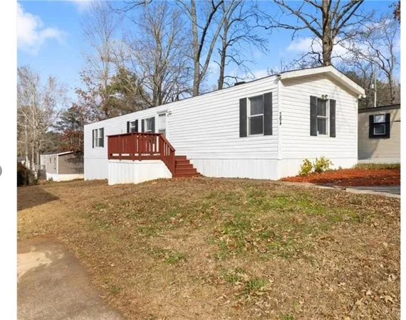 a view of a white house with a yard