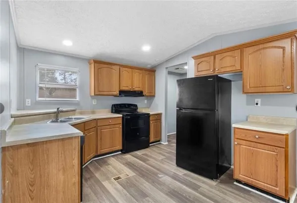 a kitchen with a refrigerator stove and sink
